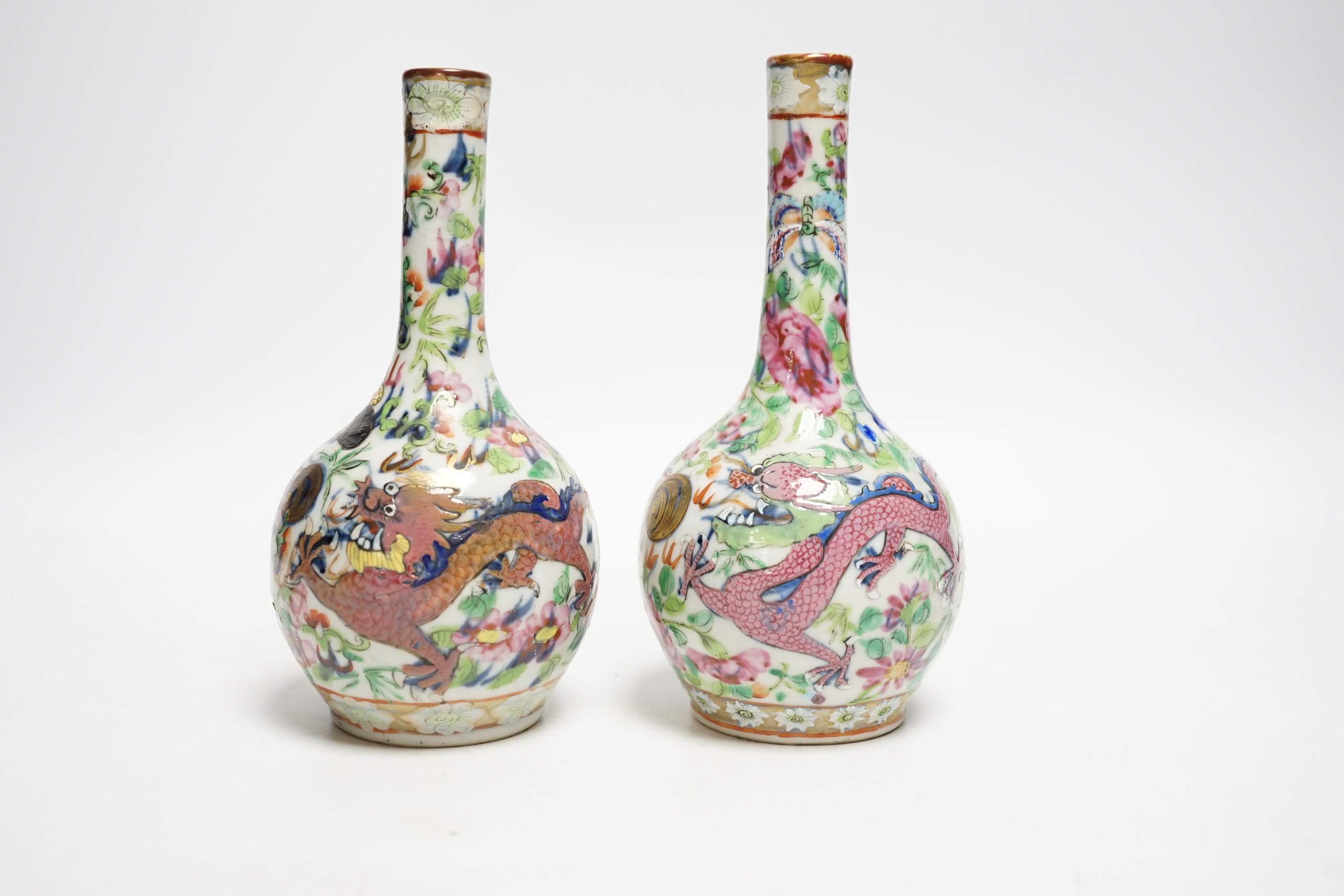 A pair of 19th century Chinese clobbered famille rose 'dragon' bottle vases, 15.5cm